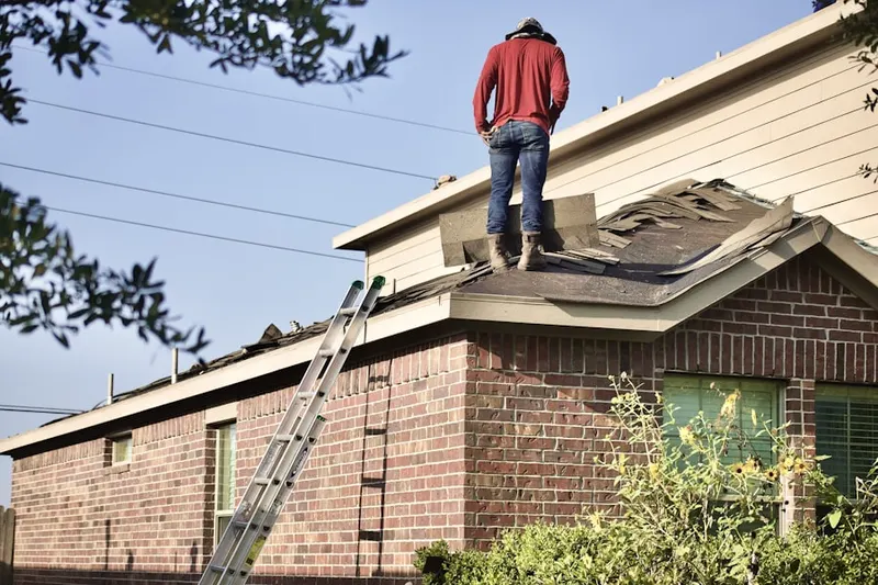 Professional roofer working on a residential roof in Zucksville